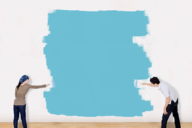 istock Asian couple paint the wall in blue 514105293