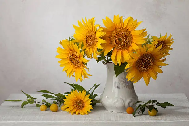 Photo of Bouquet  of sunflowers in old ceramic jug