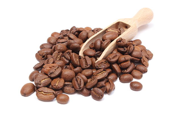 istock Heap of coffee on wooden spoon. White background 514108583