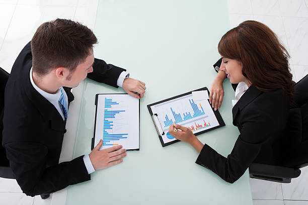 istock Business People Discussing Over Graphs In Office 514108849