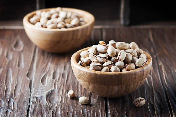 istock Salt pistachio nuts in the wooden bowl 514109084