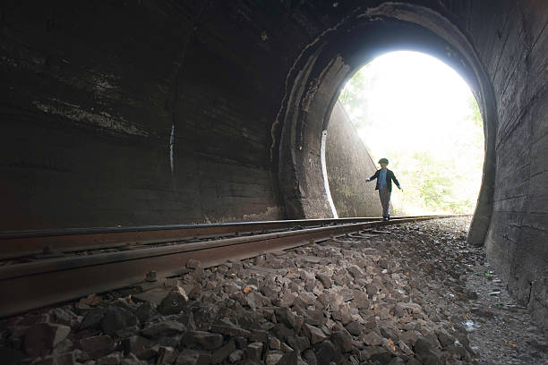 istock Child walking in railway tunnel 514112104