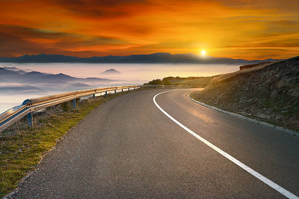 istock Driving on asphalt mountain road towards the sun 514112238