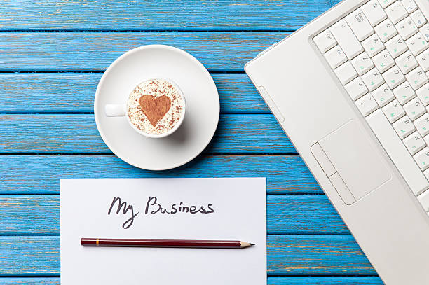 istock paper, coffee and laptop lying on the table 514113752