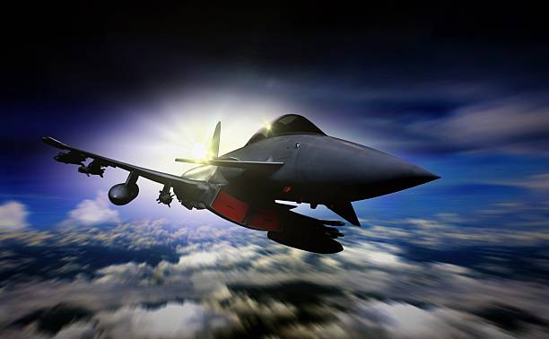 istock Military jet flying during sunrise with blur motion background 514114442