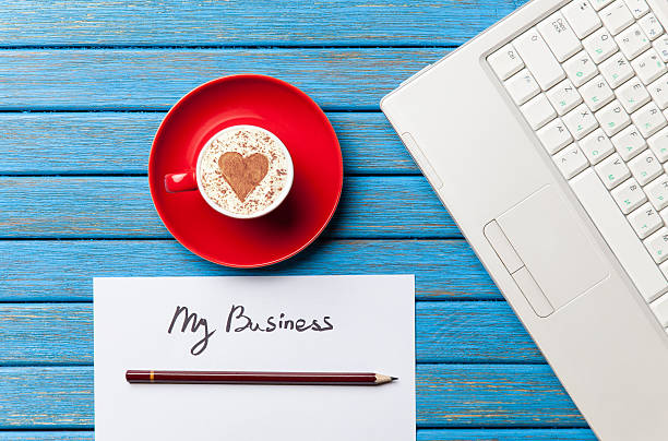 istock paper, coffee and laptop lying on the table 514114894