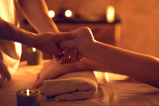 Unrecognizable woman getting foot massage at spa.