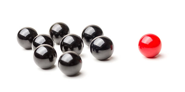 Concept with red and black marbles -  Mobbing Concept with red and black marbles -  Mobbing marble sphere stock pictures, royalty-free photos & images