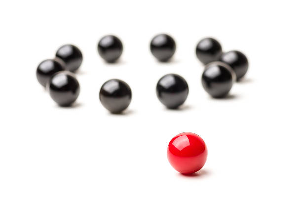 istock Concept with red and black marbles -  Outsider 514117526