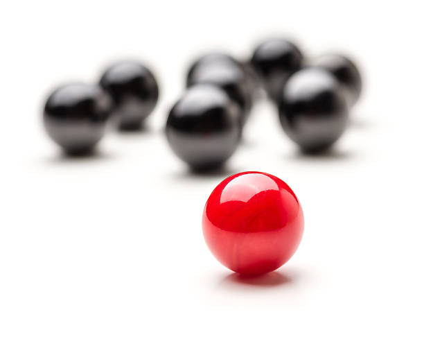 Concept with red and black marbles - Teamleader Concept with red and black marbles - Teamleader marble sphere stock pictures, royalty-free photos & images