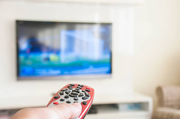istock Watching soccer on a smart TV remote control in hand 514119116