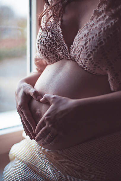 istock Heart from hands, love sign over tummy 514119190