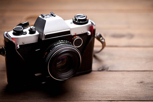 istock Vintage camera on old wooden table 514119740