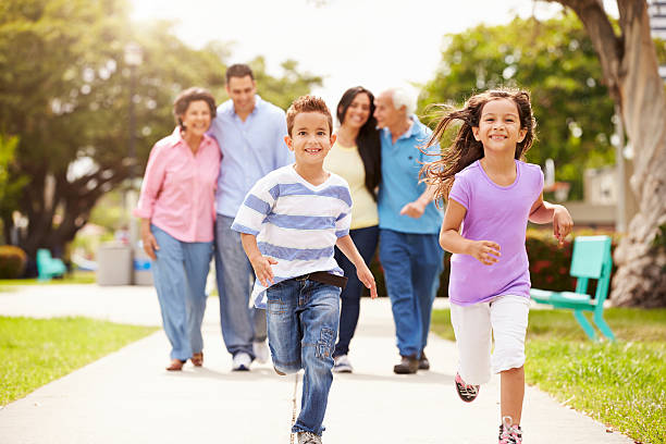 multi-generazione famiglia a piedi nel parco insieme - fun walk immagine foto e immagini stock