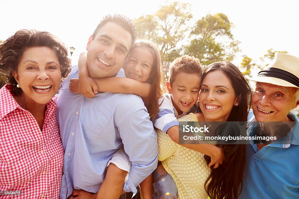 Multi Generation Family Having Fun In Garden Together Multi Generation Family Having Fun In Garden Together Smiling To Camera Latin American and Hispanic Ethnicity Stock Photo