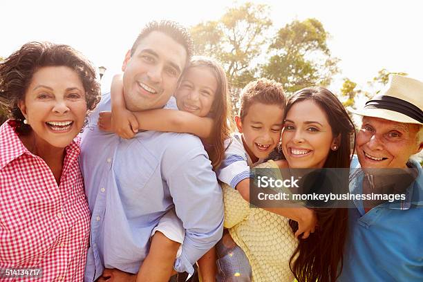 Multi Generation Family Having Fun In Garden Together Stock Photo - Download Image Now