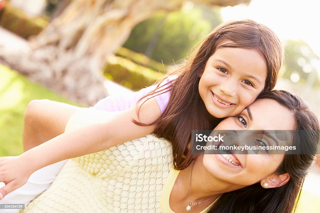 Portrait Of Hispanic Mother And Daughter In Park Portrait Of Hispanic Mother And Daughter In Park Smiling To Camera Latin American and Hispanic Ethnicity Stock Photo