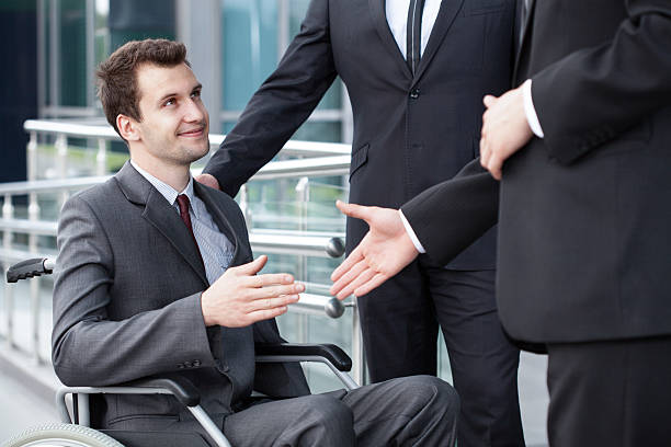 istock Disabled businessman shaking hand with business partners 514135085