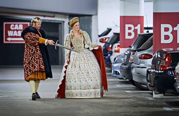 Stand back m'lady, I'll deal with these creatures! A king and queen in a parking garage viewing cars suspiciously funny parking lot stock pictures, royalty-free photos & images