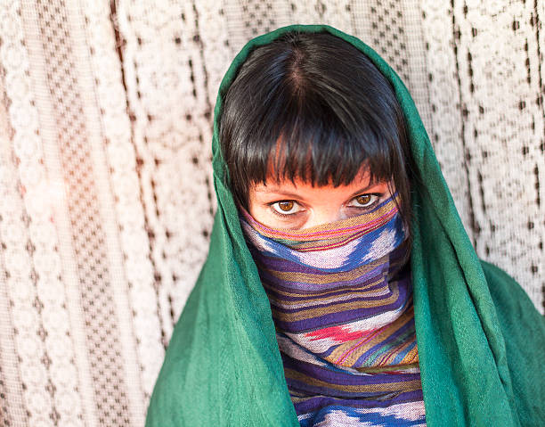 istock Young girl covers her face with a veil. Hijab. 514137027