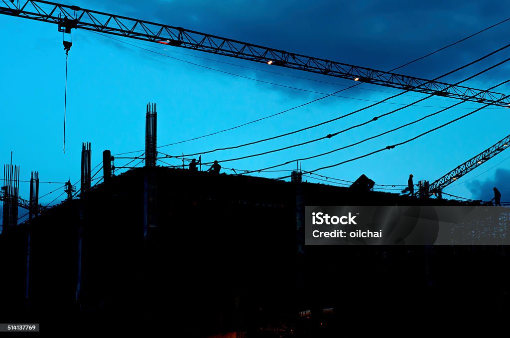 Construction building and crane Construction building and crane with silhouettes Activity Stock Photo