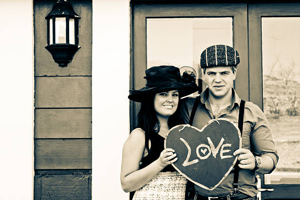 Young beautiful couple in love outdoor in the city looking the eye - love, romantic, relationship concept. Black and white