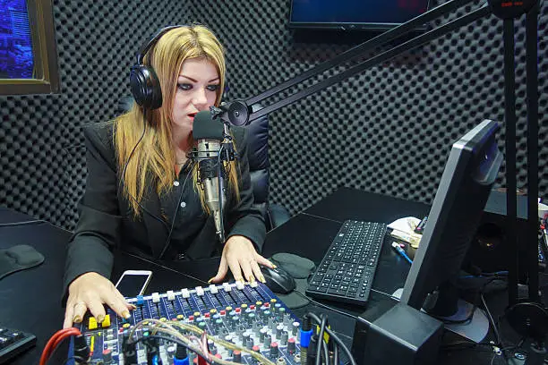 Photo of Beautiful Woman Recording Sound In Media Studio