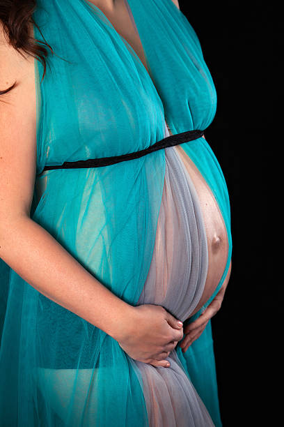 istock Pregnant belly wrapped in blue veil 514149170