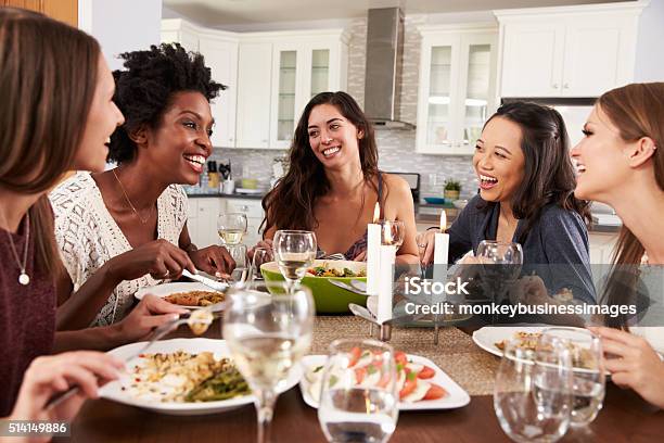 Group Of Female Friends Enjoying Dinner Party At Home Stock Photo - Download Image Now