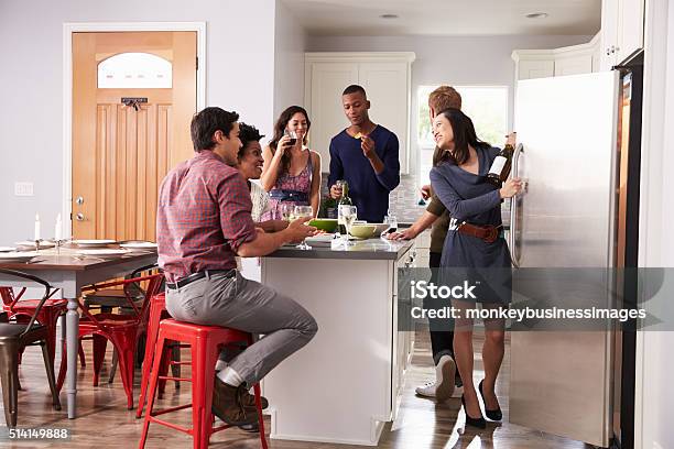 Group Of Friends Enjoying Pre Dinner Drinks At Home Stock Photo - Download Image Now