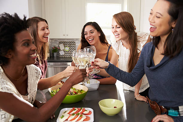 istock Group Of Female Friends Enjoying Pre Dinner Drinks At Home 514149930