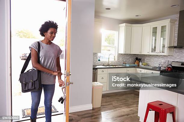 Woman Coming Home From Work And Opening Door Of Apartment Stock Photo - Download Image Now