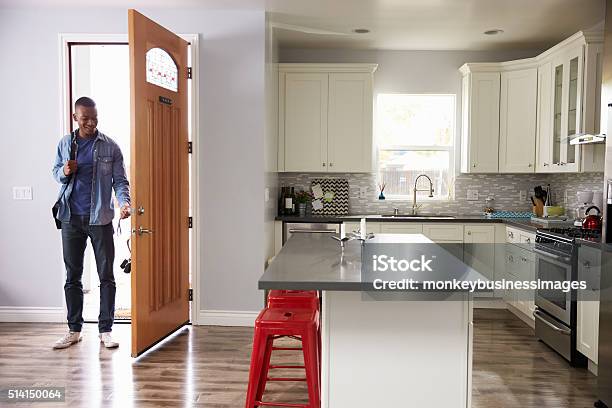 Man Coming Home From Work And Opening Door Of Apartment Stock Photo - Download Image Now