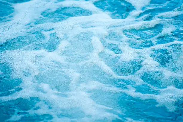 Photo of Blue clear fresh Water in hot tub. Spa massage background.