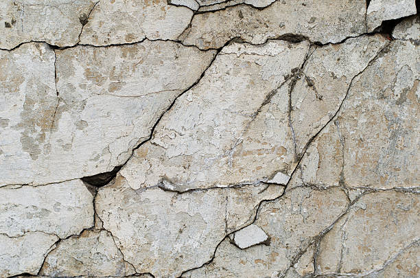 istock Gray plaster weathered wall with stains and cracks 514150504