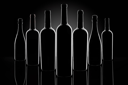 Silhouette of wine bottles on a black background