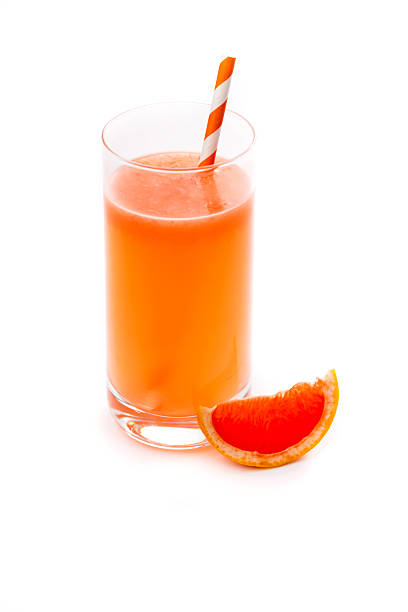 istock Glass of pink grapefruit juice isolated on white 514150966