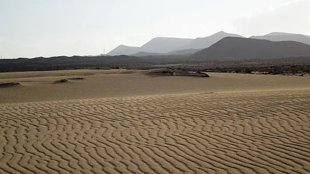 Sand pattern with mountains in the background, , Park Natural, Corralejo, Fuerteventura, Canary islands
