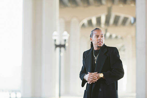 istock Young mixed race man wearing black coat 514154146