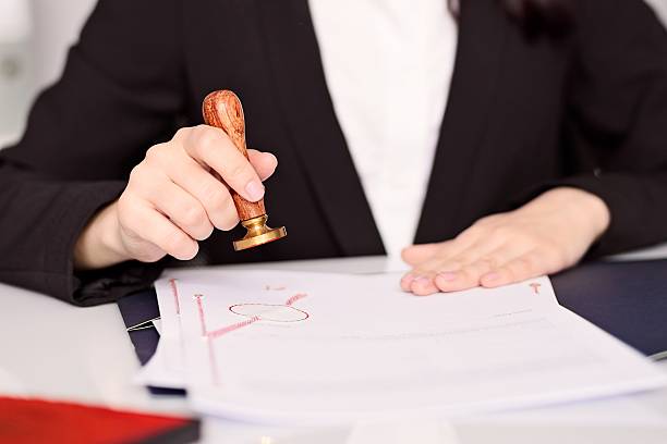 istock Notary Public woman hands stamping notary act . 514154228