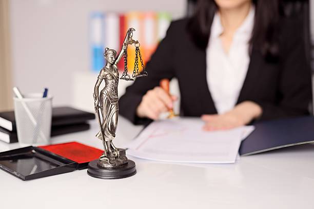 Statuette of Themis -  goddess of justice on lawyer's desk Statuette of Themis - the goddess of justice on lawyer's desk. Lawyer is stamping the document. Law office concept. shorthand photos stock pictures, royalty-free photos & images
