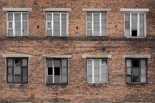 abanded factory wall of red brick with brocken windows