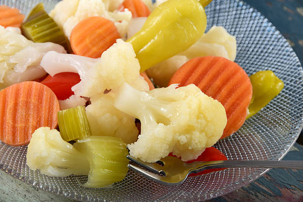 Giardiniera or Italian Mixed Pickled Vegetables Traditional Italian or Italian-American condiment or antipasto of mixed picked vegetables including cauliflower, celery, carrots, and peppers. vinegar stock pictures, royalty-free photos & images