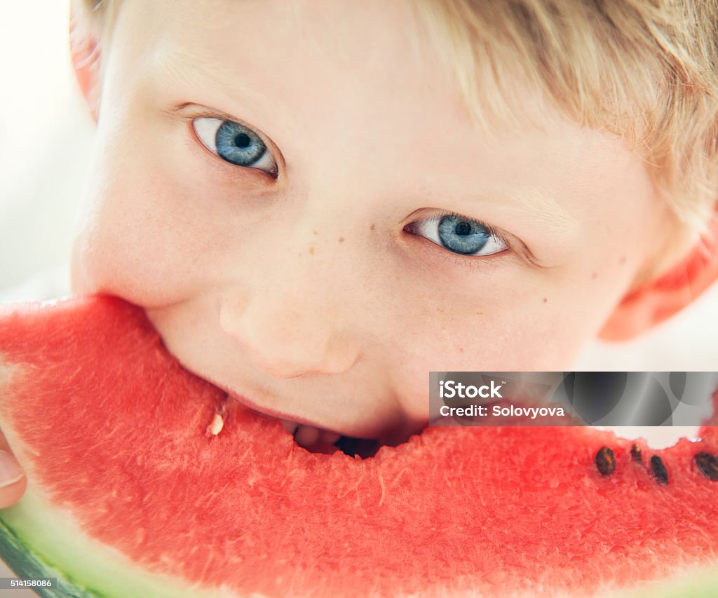 Blue eyes boy with watermelon Boys Stock Photo