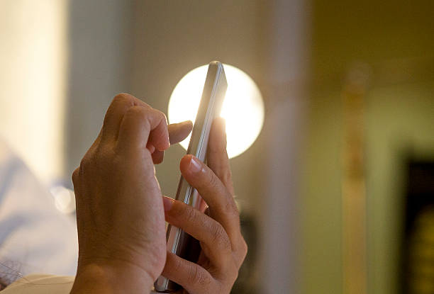 istock finger touching screen of smart phone on bed 514158388