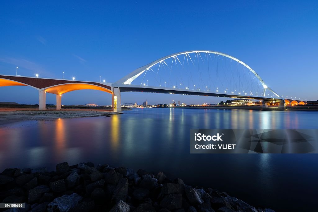 De Oversteek over the Waal River in Nijmegen De Oversteek (the crossing) is a new bridge over the Waal River in Nijmegen. It was opened on 23 November 2013 and connects the western part of the city to the northern shore. It is called de Oversteek since it is built on the location of an important rivercrossing by the Allied forces during Operation Market Garden in WWII, September 1944. The plan was to liberate the Waalbrug from the northern shore, which they managed to do, but with great losses. The bridge was opened by two of the soldiers, a daughter of General Gavin made a speech and familymembers of WWII soldiers were present. To remember the 48 American soldiers that died, every night 48 pairs of streetlights will go on one by one, from north to south. Nijmegen Stock Photo