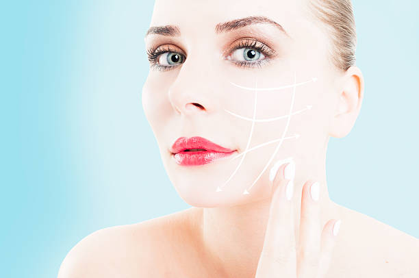 istock Close-up of female preventing wrinkles by using face cream 514159870