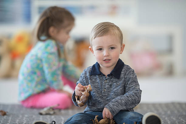istock Little Boy Happily Sitting in Preschool 514161178