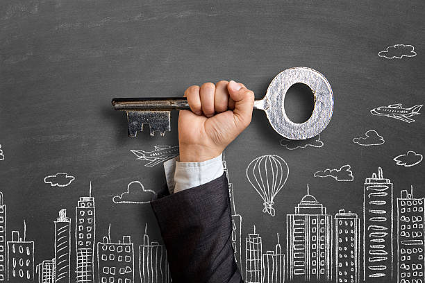 Businessman's hand showing a large key