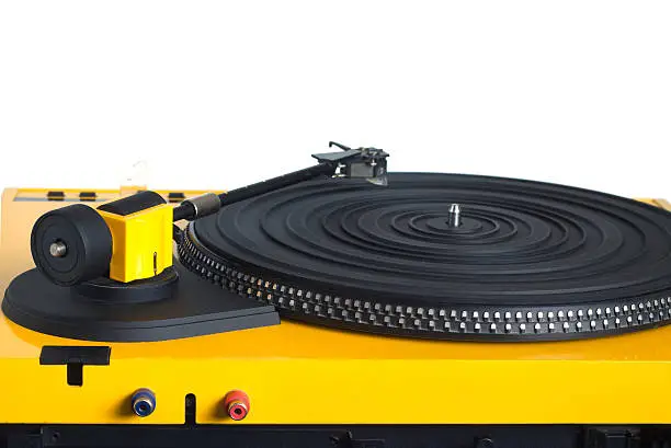 Turntable with black tonearm in yellow case with rubber mat on disc with stroboscope marks with output connectors rear view isolated on white background. Horizontal view closeup